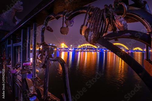 Close up padlocks are placed on the bridge as symbol of love. Dragon Bridge as seen from the Love Bridge © Krzysztof Wiktor