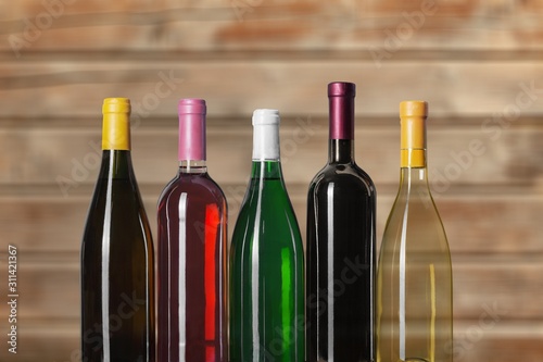 Wine bottles in row on wooden background