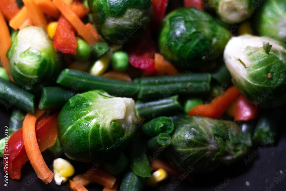 Vegetables: Brussels sprouts, broccoli, bell pepper, corn, carrots, peas, beans, onions. Grilled vegetables. Vegetables in a pan, stewed vegetables.