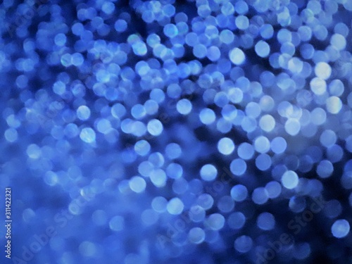  close-up of decorative abstract window surface after rain with blur / bokeh effect in classic blue color
