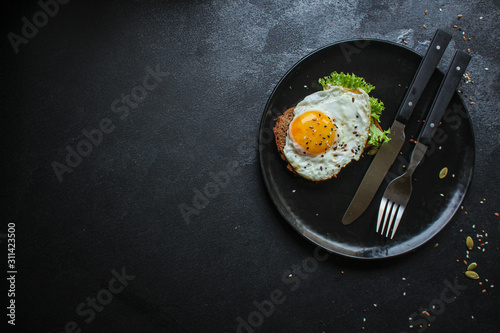 fried eggs in avocado (healthy food, vitamins) menu concept. food background. top view. copy space