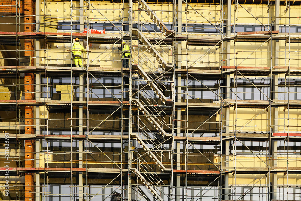 scaffolding arround the house to install thermal insulation of the apartment building facade