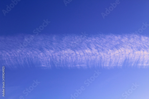 Contrail from an airplane in the sky. Close-up. Horizontal view. Background. Texture.