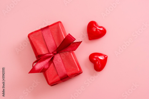 Red gift box on pink background isolated. Valentine's day mock up with copy space.