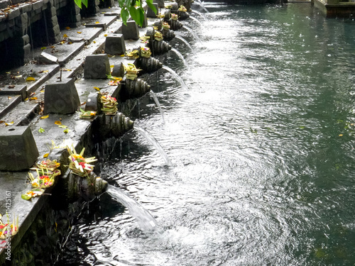 rain storm at holy water temple on the island of bali photo