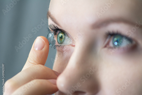 girl wearing soft contact lenses close-up macro photo