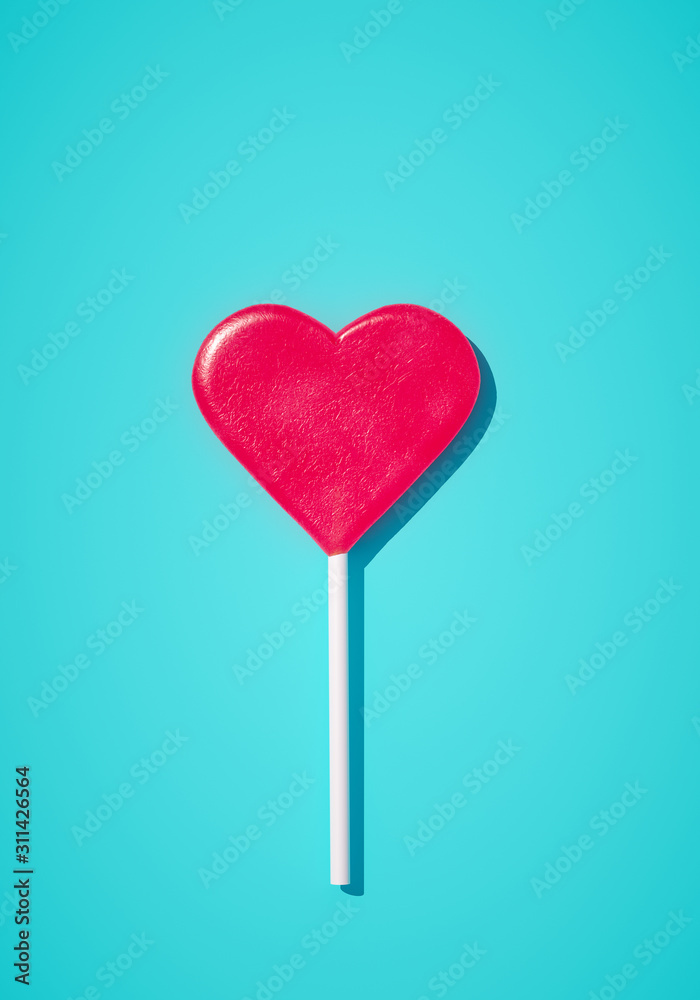 Minimalist love Valentine day concept, romantic idea. Heart red lollipop on blue background. 3d rendering.