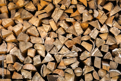 Stacked cut logs closeup. Background from cut birch firewood.