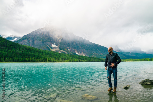 Young Man Outdoors On Lake In National Park With Sunglasses