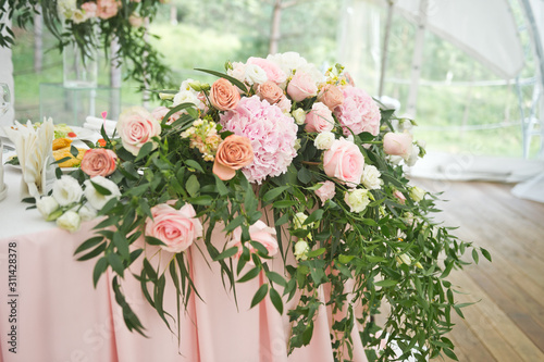 Elements of decoration of the festive hall in the form of bouquets of flow