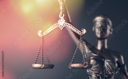 Bronze justice lady with scales on background