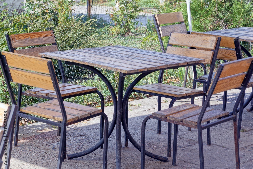 table and chairs stand on the street on the sidewalk table and chairs stand on the street on the sidewalk