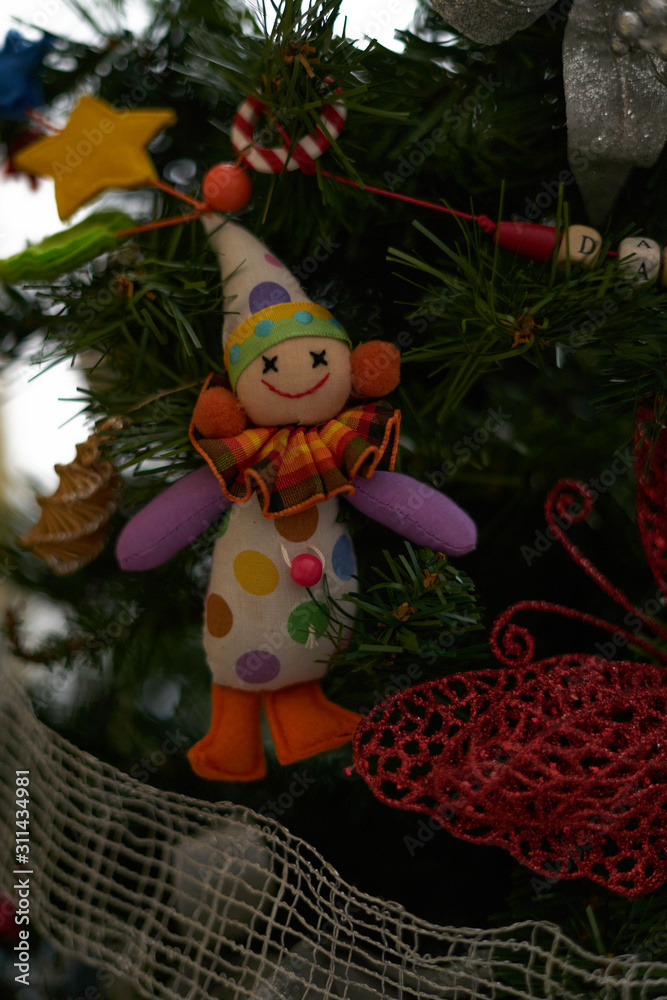 clown ornament on Christmas tree on white background