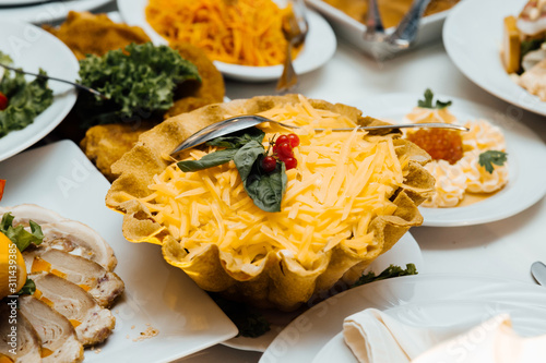 Cold appetizers and salads on the wedding table. Catering service. Restaurant table with food. Huge amount of food on the table. Plates of food. Dinner time, lunch.