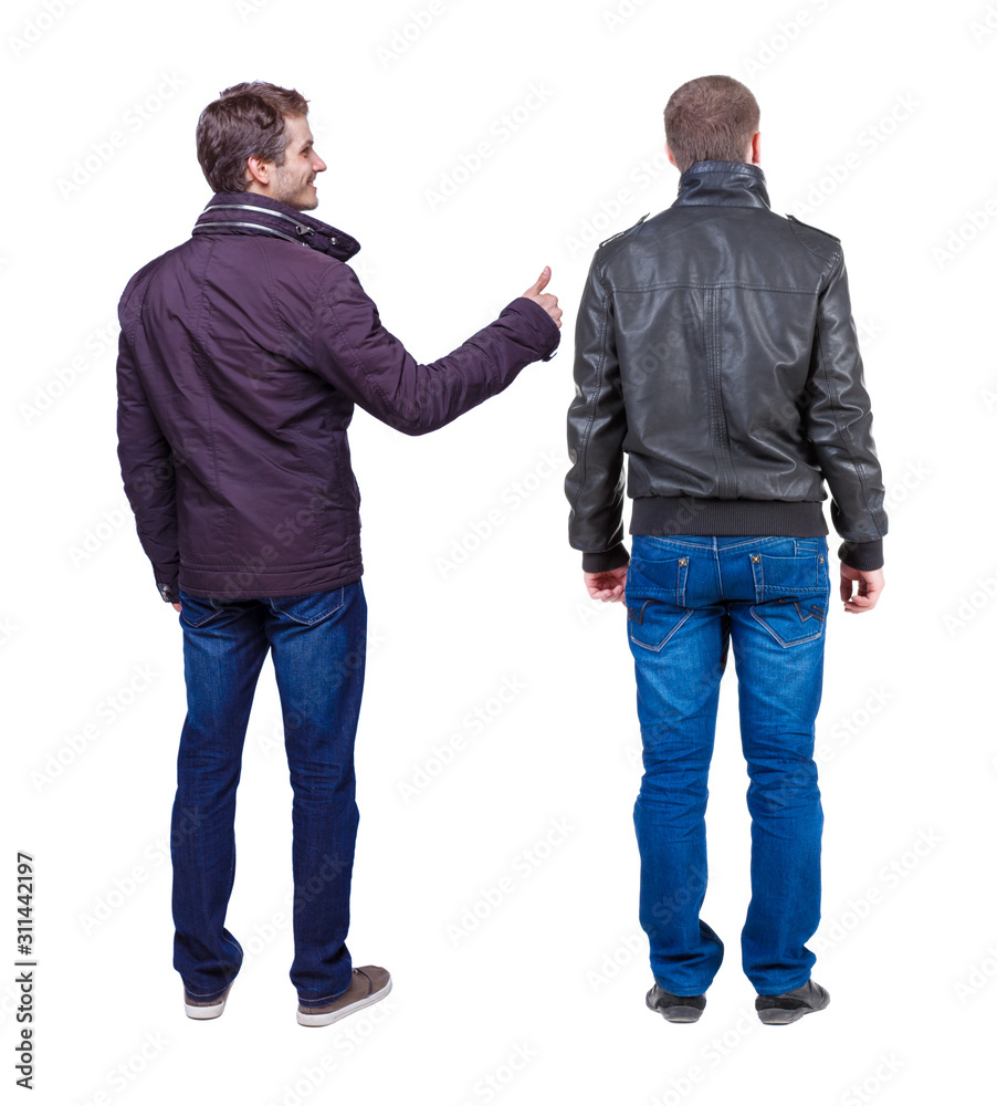 Back view of two man in winter jacket showing thumb up. Back view of two man in winter jacket showing thumb up.