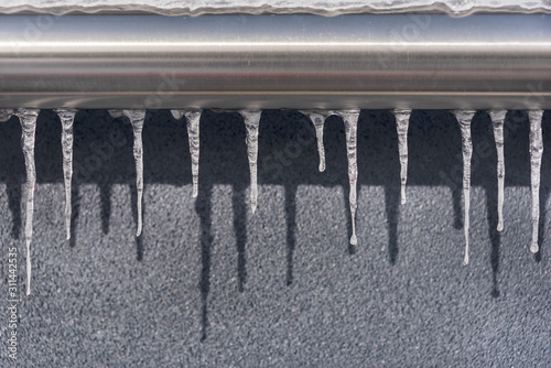 Icicles handing from a steel hand rail at Smiggin Holes ski resort  Kosciuszko National Park  NSW Australia.