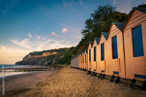 Beach huts by the sea side on a summer evening photo