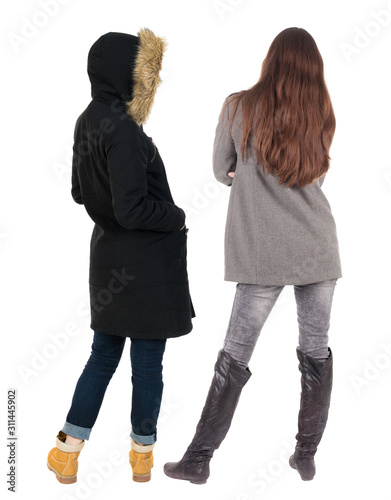 Back view of two young girl in winter jacket.