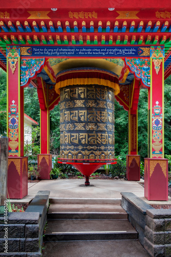 Large Buddhist Prayer Wheel. According to the Tibetan Buddhist tradition, spinning such a wheel will have much the same meritorious effect as orally reciting the prayers. 