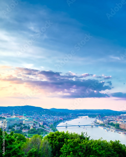 A view along the Danube River of Budapest, Hungary from Gellert Hill at sunset.