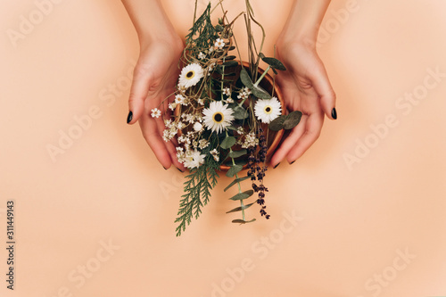 Hands with herbs mix. Flat lay style. Modern apothecary concept