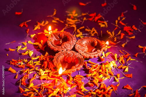 Clay diya lamps lit during Diwali Celebration. Greetings Card Design Indian Hindu Light Festival called Diwali photo