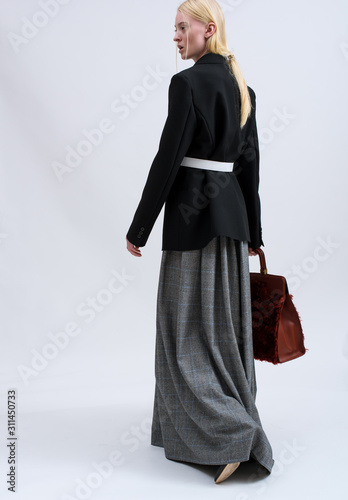 Fashion shooting in studio . Professional model of blonde, fashionable clothes and style, new collection. stylish look.