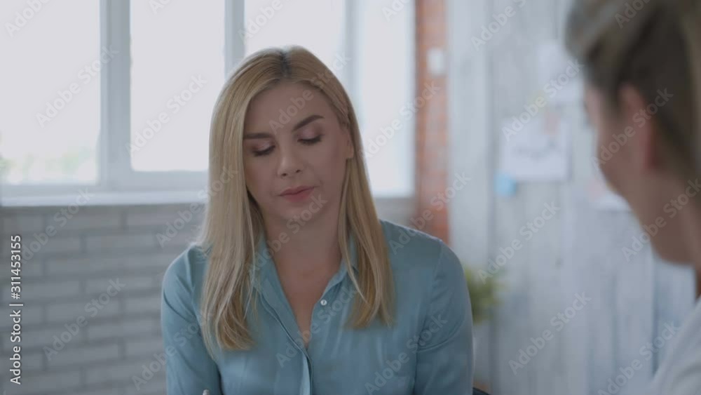 beautiful modern loft office, two women work on the idea women talk among themselves. Close-up 4k beautiful modern loft office, two women work on the idea women talk among themselves. Close-up 4k