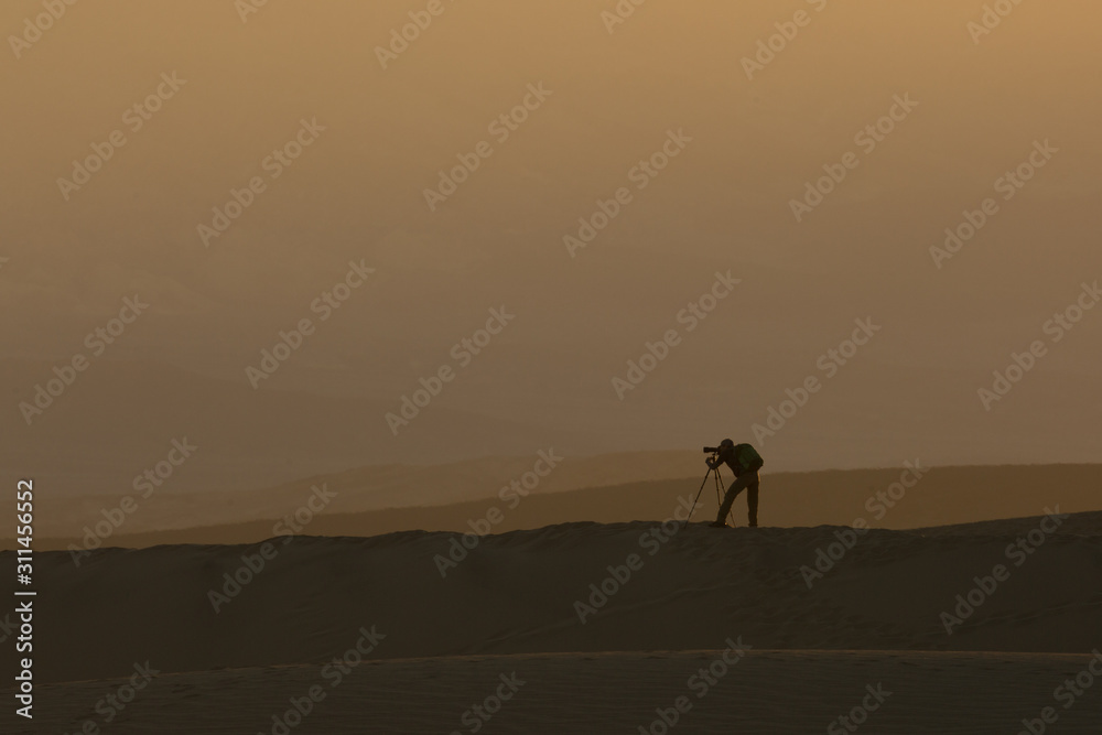 Photographer At Sunset Sunrise On Desert Sand Dunes