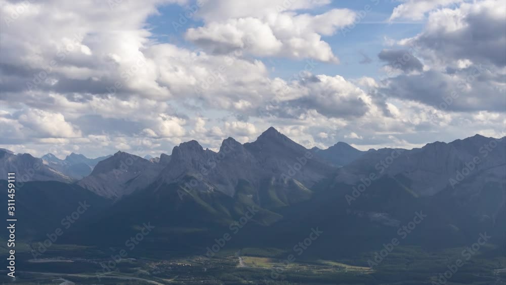 Beautiful Time Lapse View of Canadian Rocky Mountain Landscape during a cloudy and rainy day. Taken from Mt Lady MacDonald, Canmore, Alberta, Canada. Beautiful Time Lapse View of Canadian Rocky Mountain Landscape during a cloudy and rainy day. Taken from Mt Lady MacDonald, Canmore, Alberta, Canada.