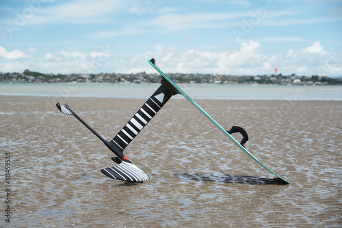 A kitesurfing hydrofoil board on the beach at low tide, Wai O Taki Bay, Glendowie, Auckland, New Zealand.