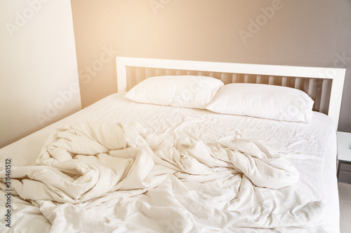 Fototapeta Naklejka Na Ścianę i Meble -  Two white pillow on bed and blanket with wrinkle messy