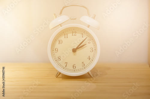 Alarm clock on the wood table beside the bed