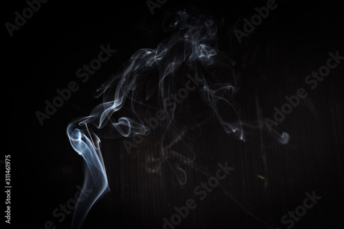 Abstract smoke swirls on black background