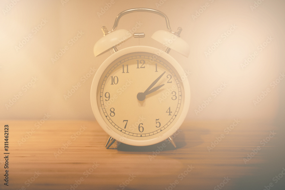 Alarm clock on the wood table beside the bed Alarm clock on the wood table beside the bed
