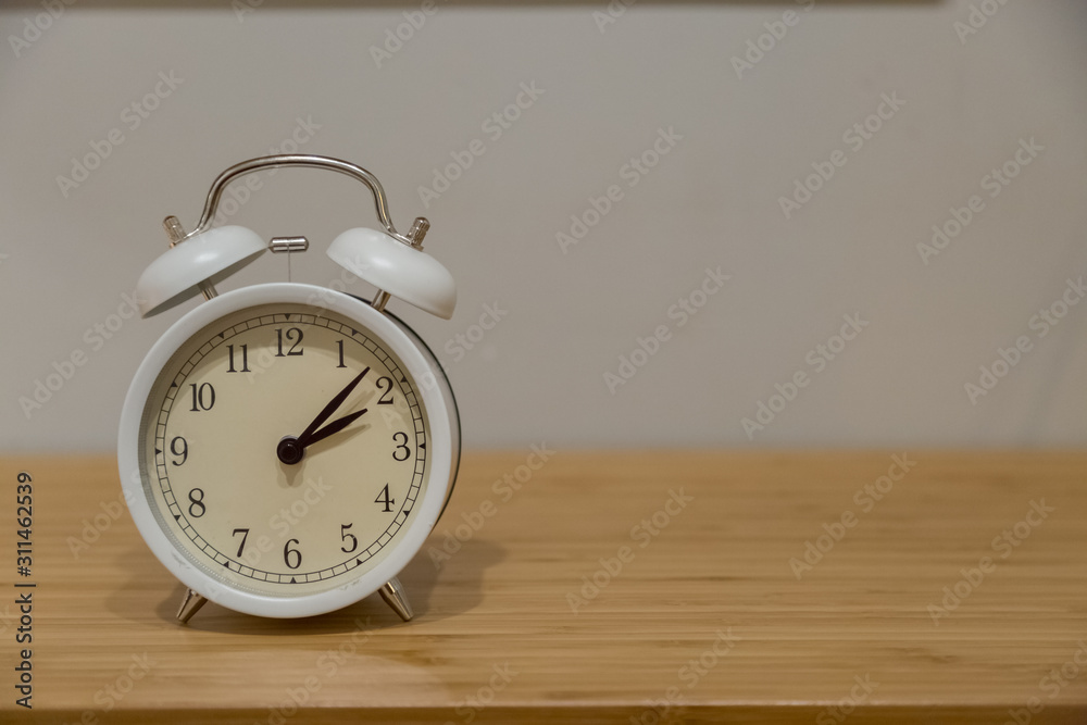 Alarm clock on the wood table beside the bed Alarm clock on the wood table beside the bed