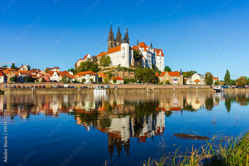 View on the Albrechtsburg castle and the Gothic Meissen Cathedral, the embankment and Elbe river on the foreground.