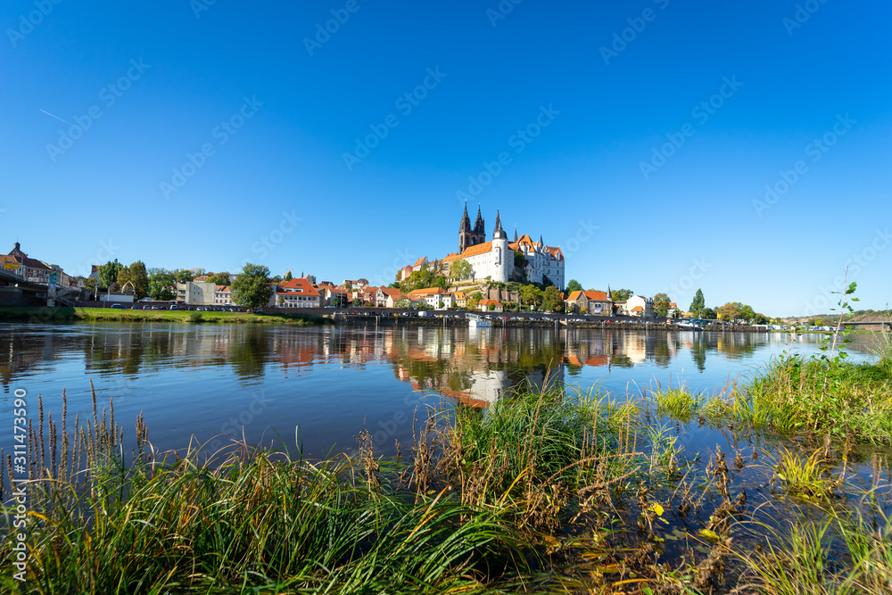 View on the Albrechtsburg castle and the Gothic Meissen Cathedral, the embankment and Elbe river on the foreground.