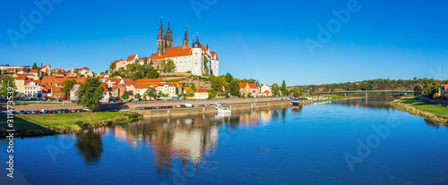 Panoramic view on the Albrechtsburg castle and the Gothic Meissen Cathedral, the embankment and Elbe river on the foreground. © Sergey Kohl