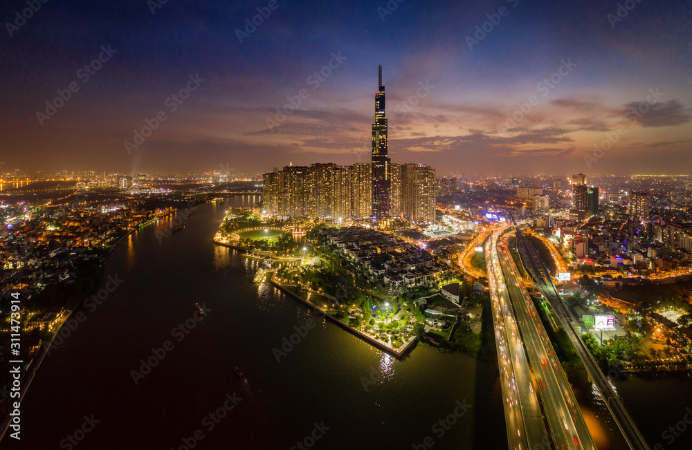 November 09/2019 - Aerial view Skyscrapers flying by drone of Ho Chi Mi City with development buildings, transportation, energy power infrastructure. include Landmark 81 by night