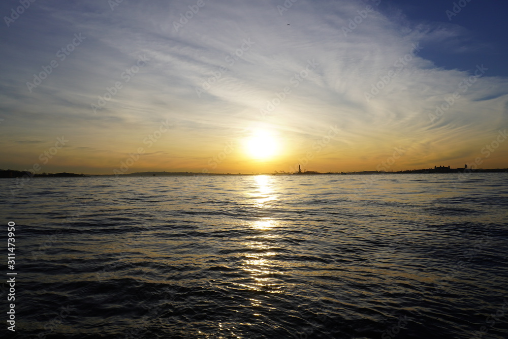 sunset over the sea statue of liberty New York City