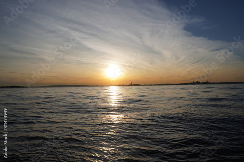 sunset over the sea statue of liberty New York City