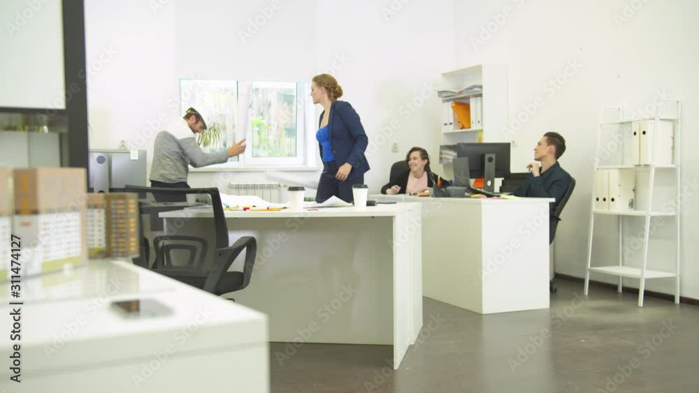 Man in helmet and woman fight with whatmans, their workmates laugh at them Man in helmet and woman fight with whatmans, their workmates laugh at them