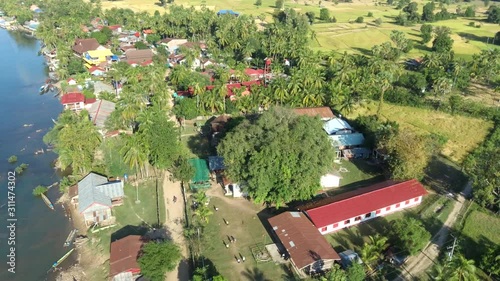 Aerial of Don Det and Don Khon islands showing the calm and peaceful rural life on the banks of Mekong river, South Laos. Backward moving. photo