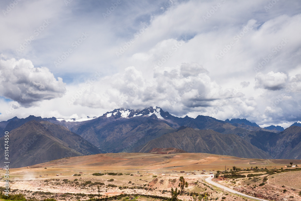 Mountain range in the clouds, in the foreground desert terrain