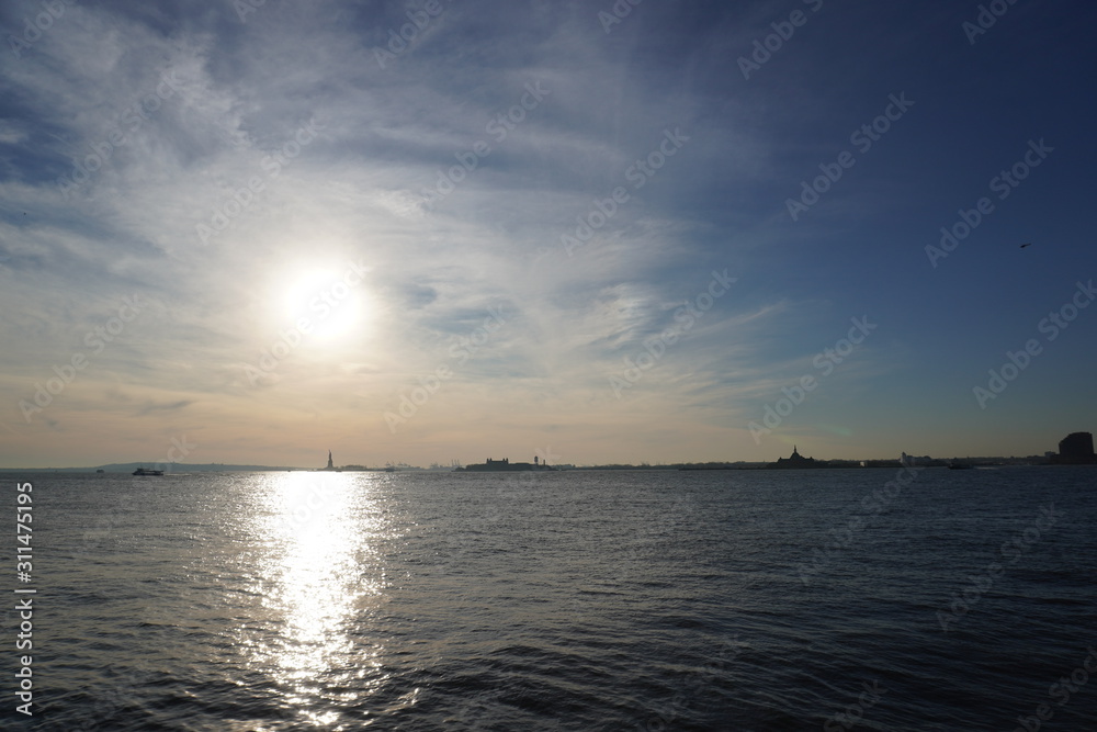 sunset over the sea statue of liberty 