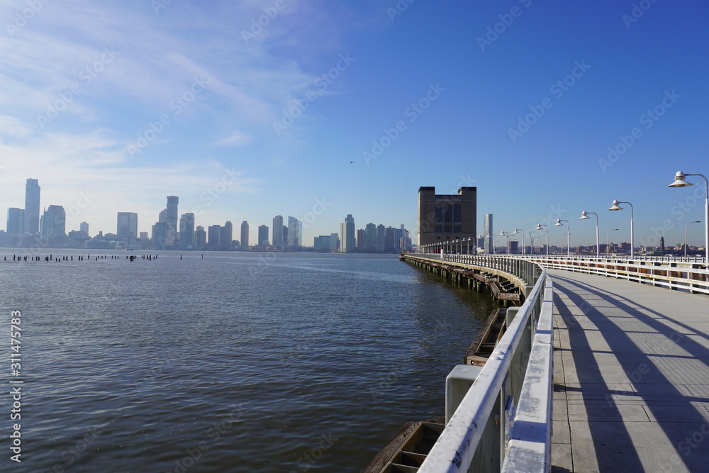 bridge and manhattan skyline curve boardwalk bridge and manhattan skyline curve boardwalk