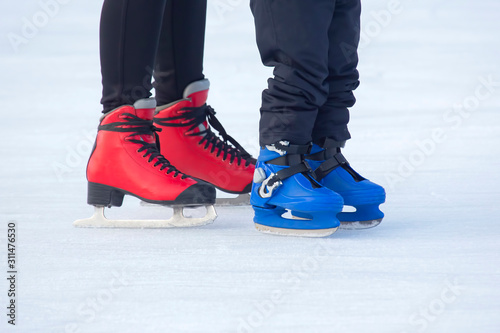 different people are actively skating on an ice rink. Hobbies and sports. Vacations and winter activities.