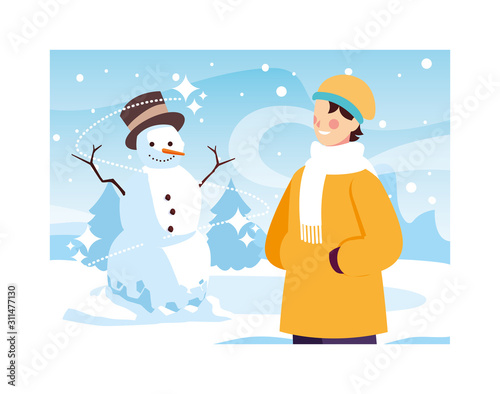 man with snowman in winter landscape