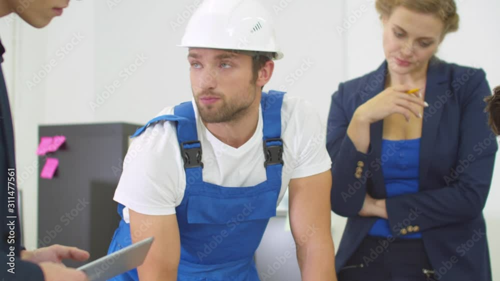 Builder in uniform explain project of houses to engineers Builder in uniform explain project of houses to engineers